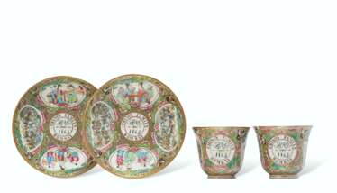 A RARE PAIR OF 'CANTON FAMILLE ROSE' DATED AND INITIALED TEA CUPS AND SAUCERS