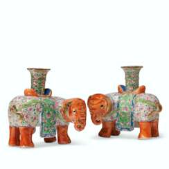 A PAIR OF 'CANTON FAMILLE ROSE' ELEPHANT CANDLEHOLDERS