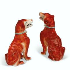A PAIR OF IRON-RED HOUNDS