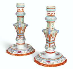 A RARE PAIR OF FAMILLE ROSE CANDLESTICKS