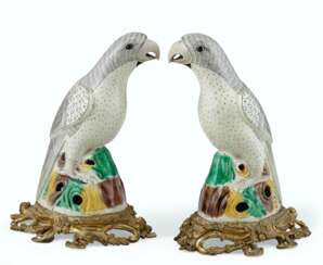 A PAIR OF ORMOLU-MOUNTED BISCUIT-GLAZED PARROTS