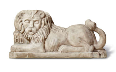 A CARVED WHITE MARBLE RECUMBENT LION