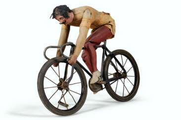 AN ARTICULATED PAINTED PINE AND FABRIC CYCLIST