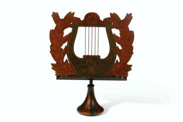 A CARVED AND STENCIL-PAINTED PINE LYRE-FORM MUSIC STAND