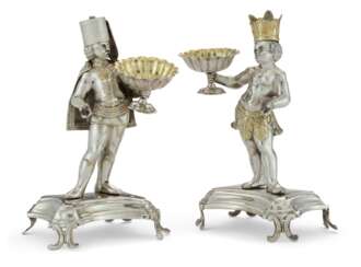 A PAIR OF CONTINENTAL PARCEL-GILT SILVER FIGURAL SALT CELLARS