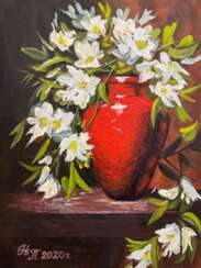"White flowers in a red vase".