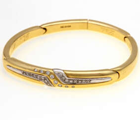 Bangle yellow gold/WG 18 K bes. with 24 Brilliant together approx 0.4 ct, sockets, brass part, dedication engraving, Ottto core;