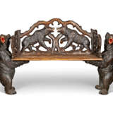 A SWISS 'BLACK FOREST' CARVED AND STAINED WALNUT BENCH - photo 1