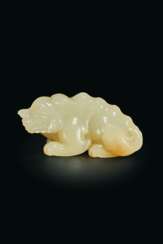 A FINELY CARVED WHITE JADE FIGURE OF A MYTHICAL BEAST