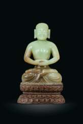 A FINELY CARVED YELLOWISH-GREEN JADE FIGURE OF A SEATED BUDDHA