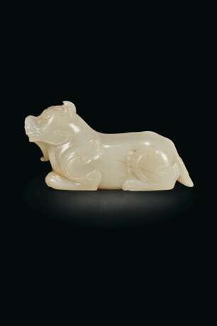 A FINELY CARVED WHITE JADE FIGURE OF A MYTHICAL BEAST - фото 1