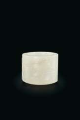 A CARVED WHITE JADE THUMB RING