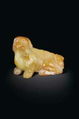 A YELLOW AND PALE RUSSET JADE FIGURE OF A MYTHICAL BEAST