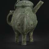 THE RAN FU BING HE
A RARE AND FINELY CAST BRONZE RITUAL TRIPOD WINE VESSEL AND COVER, HE - photo 3