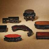 A GROUP OF SEVEN ELABORATELY CARVED WOOD STANDS - фото 1