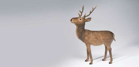 A CARVED WOOD SCULPTURE OF A DEER - photo 1