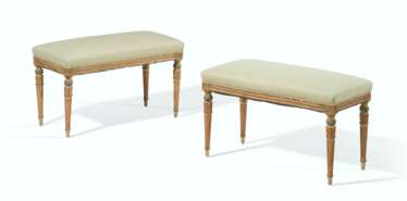 A PAIR OF FRENCH GREEN AND CREAM-PAINTED AND PARCEL-GILT BANQUETTES