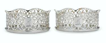 A PAIR OF GEORGE III SILVER WINE COASTERS