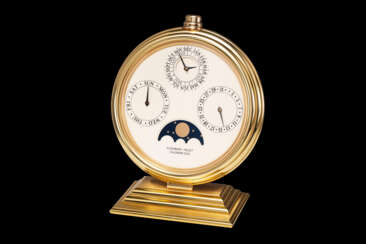 AUDEMARS PIGUET, A GILT BRASS PERPETUAL CALENDAR 2100 DESK CLOCK