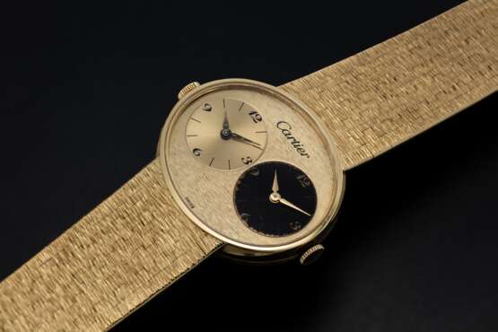 Patek Philippe. PIAGET, A GOLD DUAL TIME BRACELET WATCH RETAILED BY CARTIER - photo 1
