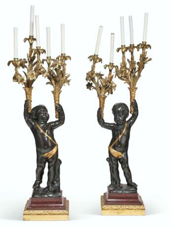 A LARGE PAIR OF FRENCH ORMOLU, PATINATED AND PARCEL-GILT BRONZE AND ROUGE GRIOTTE MARBLE FIGURAL FIVE-LIGHT CANDELABRA - фото 1
