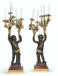 A LARGE PAIR OF FRENCH ORMOLU, PATINATED AND PARCEL-GILT BRONZE AND ROUGE GRIOTTE MARBLE FIGURAL FIVE-LIGHT CANDELABRA