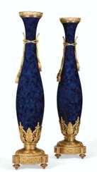 A MONUMENTAL PAIR OF FRENCH ORMOLU AND ONYX-MOUNTED MOTTLED COBALT-BLUE GROUND SEVRES STYLE PORCELAIN VASES