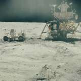 NASA. Experiments on the Moon: astronaut John Young beside the lunar rover and lunar module "Orion"; sun-drenched view of "thumper" imprints on the lunar surface; lunar rover parked on the slopes of Stone mountain, April 16-27, 1972 - фото 1
