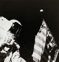 Astronaut Harrison Schmitt with the Earth above the US flag, December 7-19, 1972