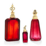 A GROUP OF THREE GERMAN SILVER-GILT AND GILT-METAL MOUNTED RUBY-GLASS SCENT BOTTLES - фото 1