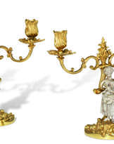 A PAIR OF ELIZABETH II PARCEL-GILT SILVER TWO-LIGHT CANDELABRA