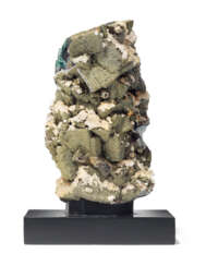 AN UPRIGHT SPECIMEN OF FLUORITE AND PYRITE