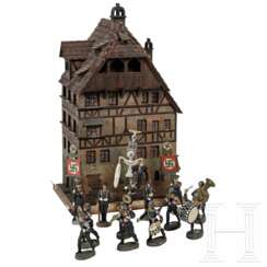 13 Elastolin-SS-Figuren mit Standartenträgern und ein Modell des Albrecht-Dürer-Hauses