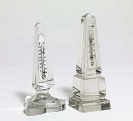 Two glass obelisks with thermometer