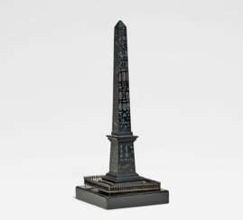 Small bronze Luxor obelisk at the Place de la Concorde in Paris