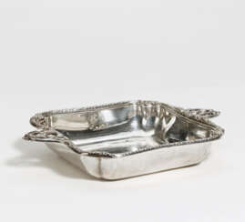 Rectangular silver serving bowl with side handles and laurel decor