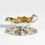 Paris. Silver gravy boat with gilt interior on fixed saucer style Rococo - photo 1