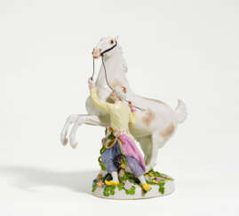 Porcelain figurine of oriental with rearing horse