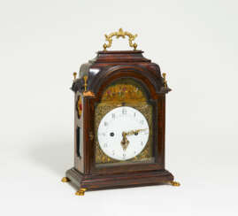 Wooden rococo commode clock with automaton and gilt appliqués