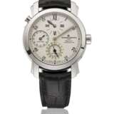 VACHERON CONSTANTIN. AN 18K WHITE GOLD AUTOMATIC DUAL TIME WRISTWATCH WITH DATE AND REGULATOR-STYLE DIAL - фото 1