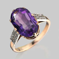 A ring of gold with natural amethyst and diamonds