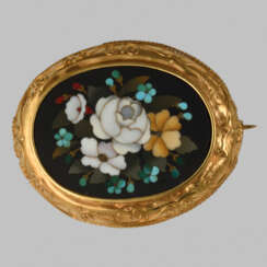 The brooch with the mosaic of natural stones