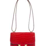 HERMÈS. A SHINY ROUGE DE COEUER ALLIGATOR MINI CONSTANCE 18 WITH GOLD HARDWARE - фото 1
