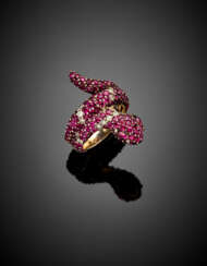 White gold snake ring accented with rubies for the most part synthetic and diamonds
