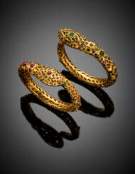 Lot comprising two gilt metal snake bangles with snap clasps accented with rubies and emeralds