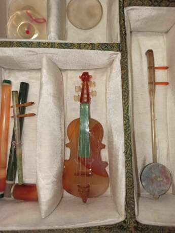Satz von 26 Miniatur-Musikinstrumenten aus verschiedenen Steinen wie Achat und Malachit gearbeitet, Holzstände, Stoffbox - Foto 6