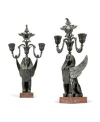 A PAIR OF FRENCH EGYPTIAN REVIVAL PATINATED-BRONZE AND ROUGE GRIOTTE MARBLE TWO-LIGHT CANDELABRA