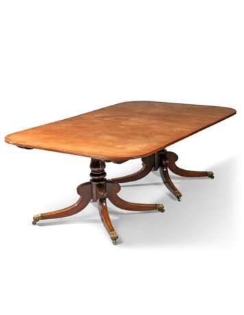 A REGENCY-STYLE MAHOGANY TWIN-PEDESTAL EXTENDING DINING-TABLE - photo 1