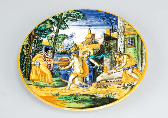 Urbino ceramic plate with bright round border and moulded center with multi colored paint of an allegorical scene in front of houses and the sea - photo 1