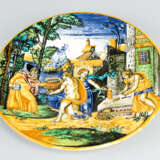 Urbino ceramic plate with bright round border and moulded center with multi colored paint of an allegorical scene in front of houses and the sea - photo 1